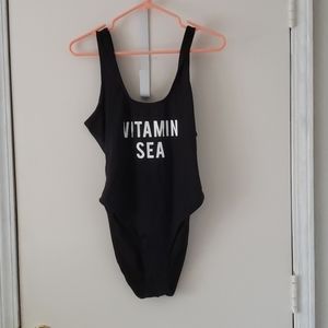 One piece black bathing suit sz 12 .
